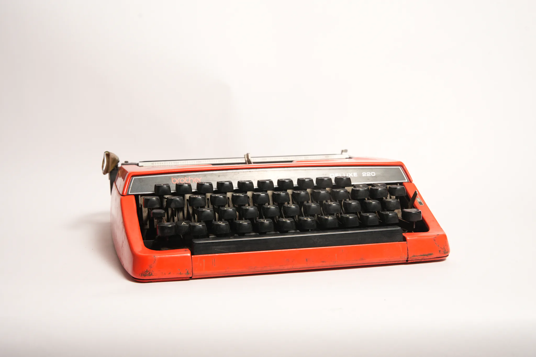 Brother Deluxe 220 Vivid Red Portable Manual Typewriter — photograph