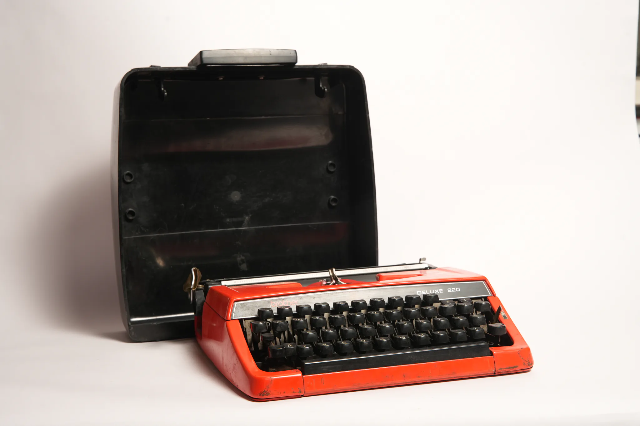 Brother Deluxe 220 Vivid Red Portable Manual Typewriter — photograph