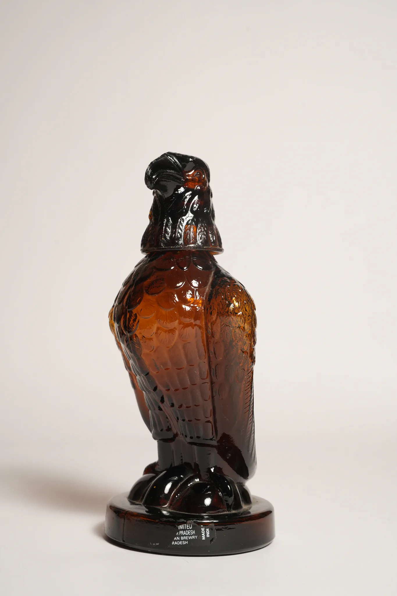 Mohan Meakin Amber Glass Eagle Decanter Bottle — photograph 1