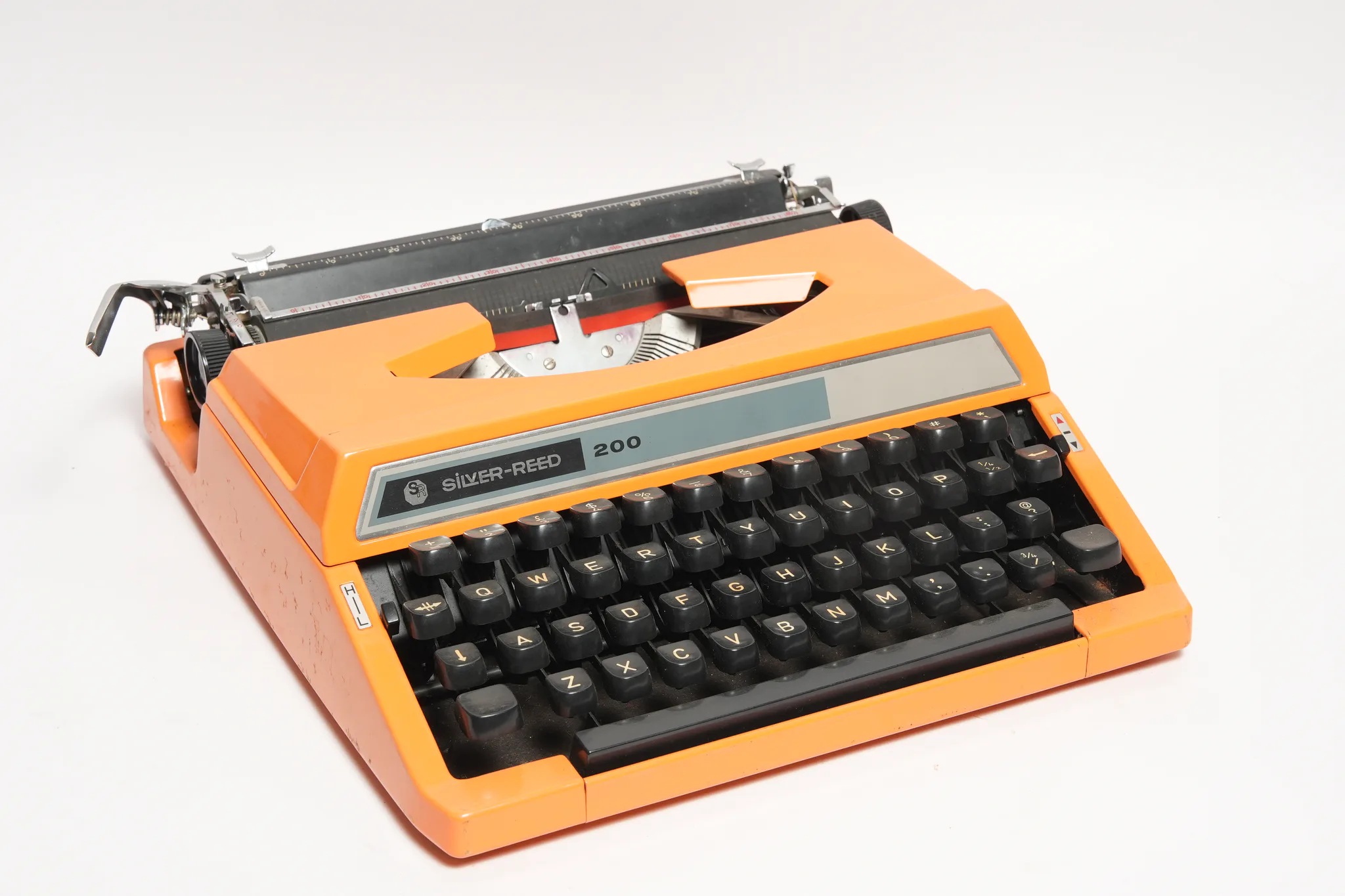 Silver-Reed 200 Portable Orange Typewriter — photograph