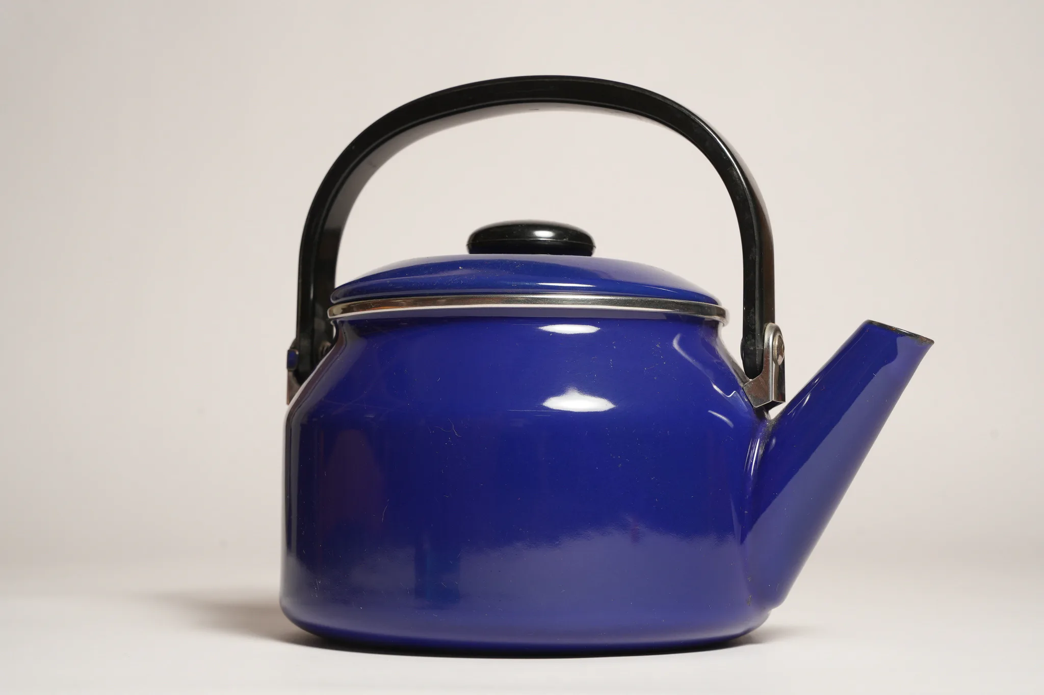 Vintage Blue Enamel Teapot with Black Handle — photograph