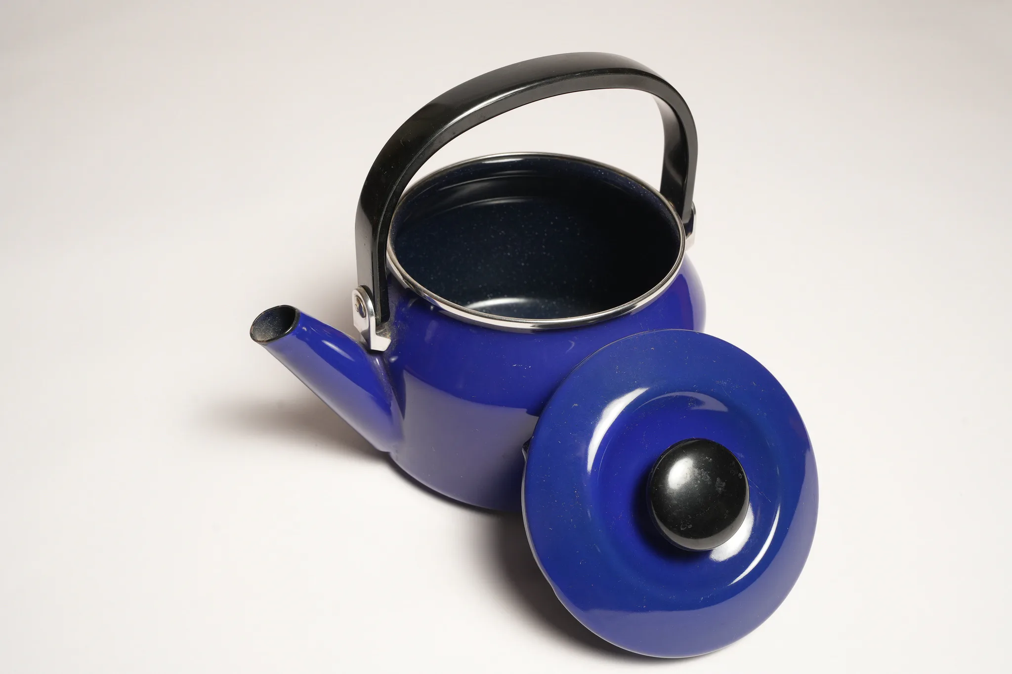 Vintage Blue Enamel Teapot with Black Handle — photograph