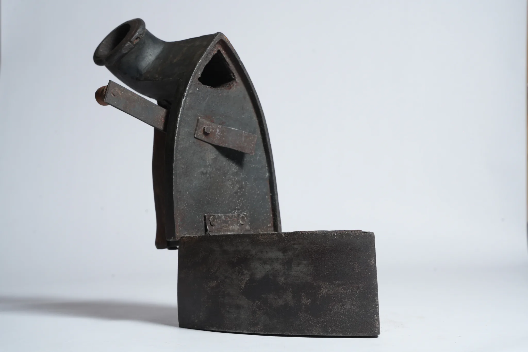 Vintage Cast Iron Charcoal Flatiron with Wooden Handle — photograph